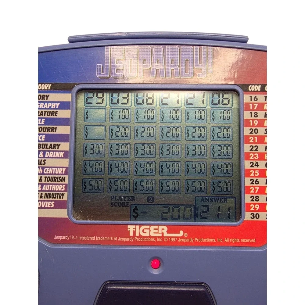 Tiger Electronics Jeopardy Hand Held Game With Cartridges & Answer Question Book